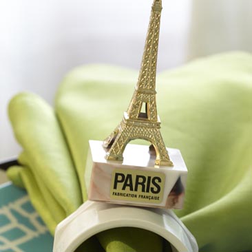Green detail of an Eiffel Tower napkin holder from a travel company's celebration, Boston Event Planner, Boston Event Planning, Boston Event Stylist, Boston Event Styling